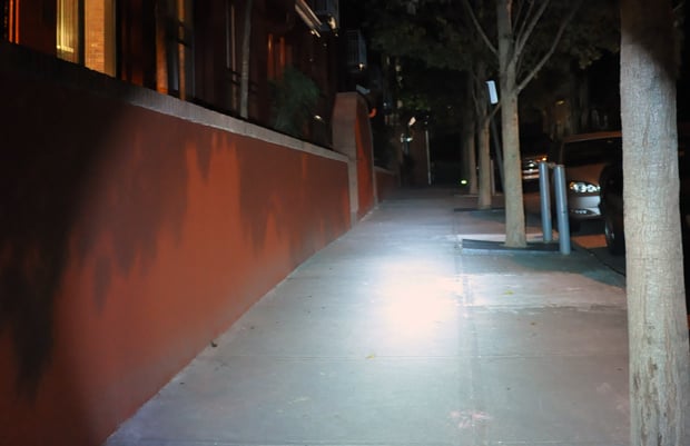 Neofab Legion II flashlight lighting up a sidewalk