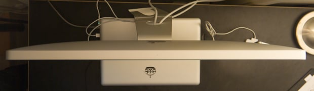 Aerial view of Apple Cinema Display setup with MacBook Pro underneath